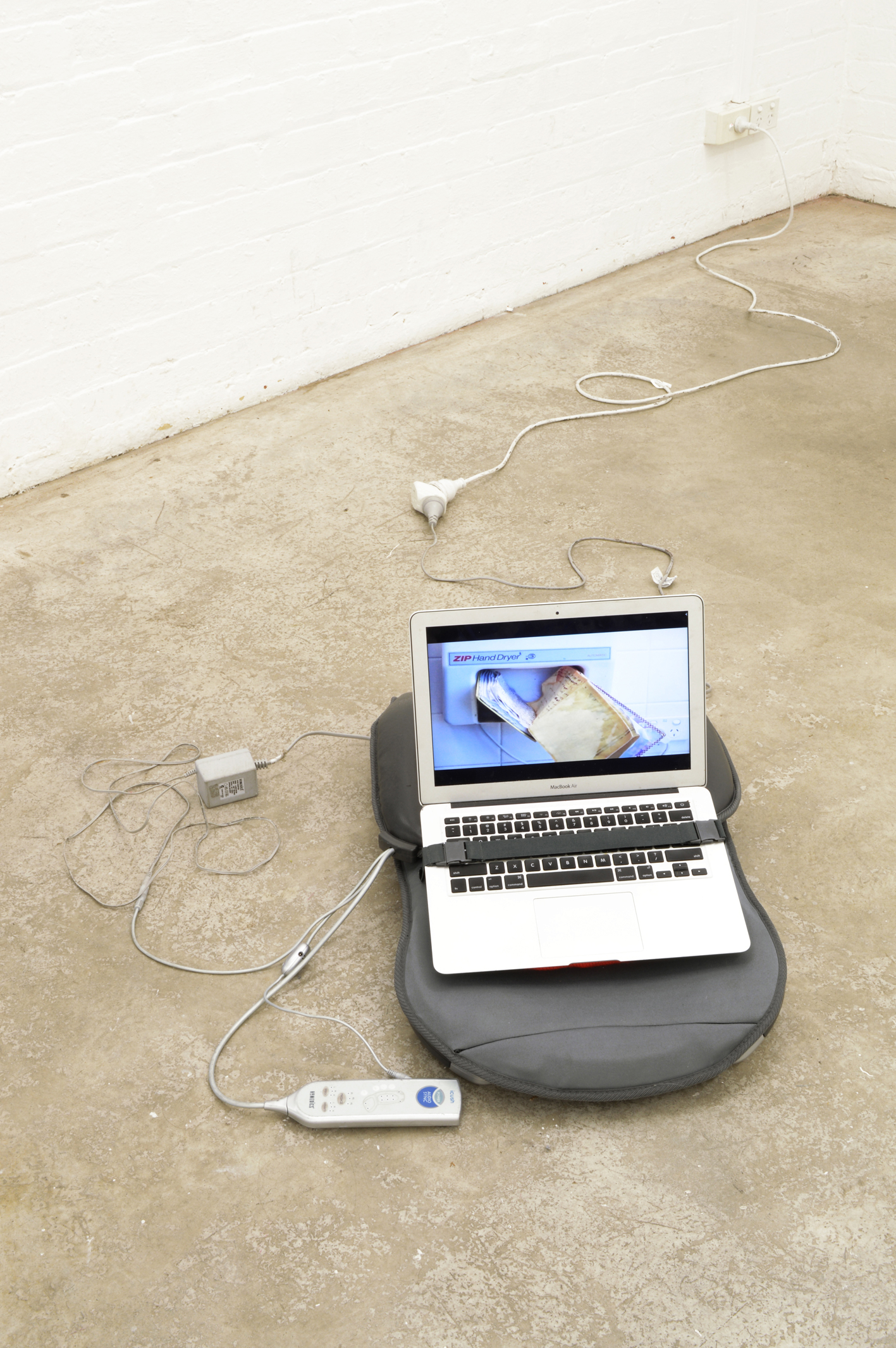 Hana Earles, “its my life”, 2015, massage chair, hot water bottle, hot water bottle jumper, laptop, 500 × 620 × 450 mm 