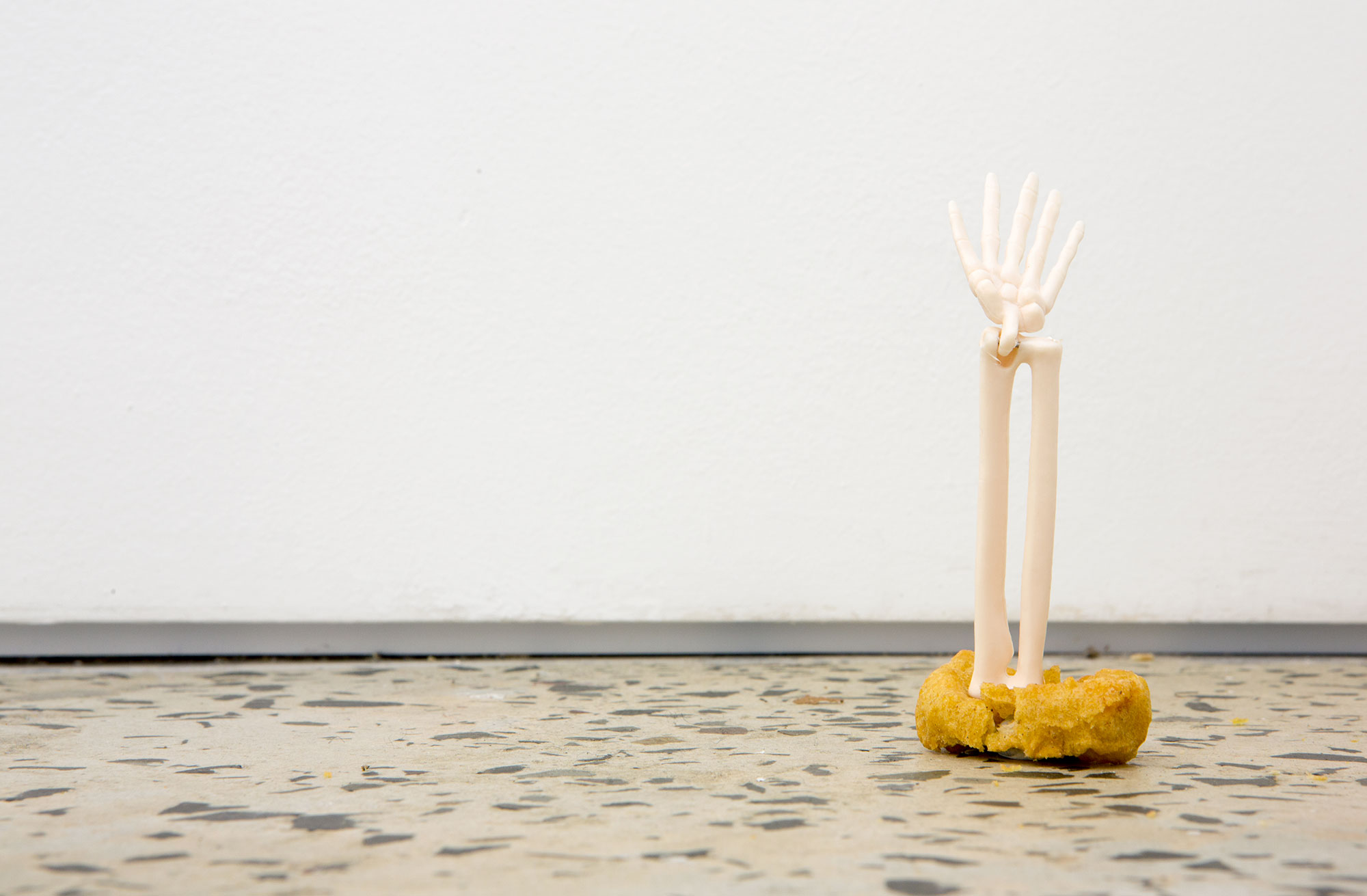 Puppies Puppies, “Skeleton Rising From The Dead (Nugget)”, 2015, anatomical model skeleton arm, washable high-quality PVC, chicken nugget, dimensions variable